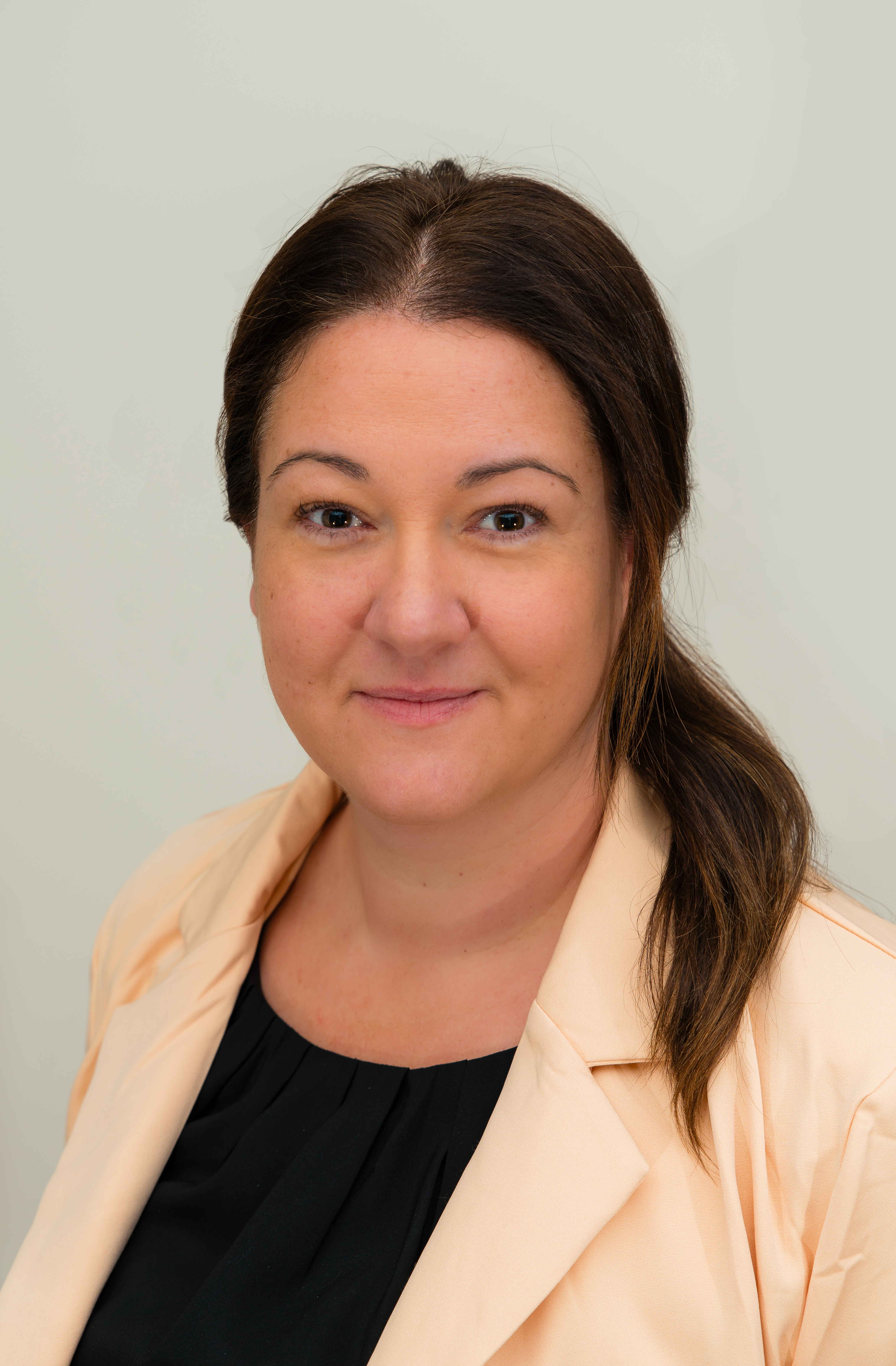 Person in business attire for a formal headshot